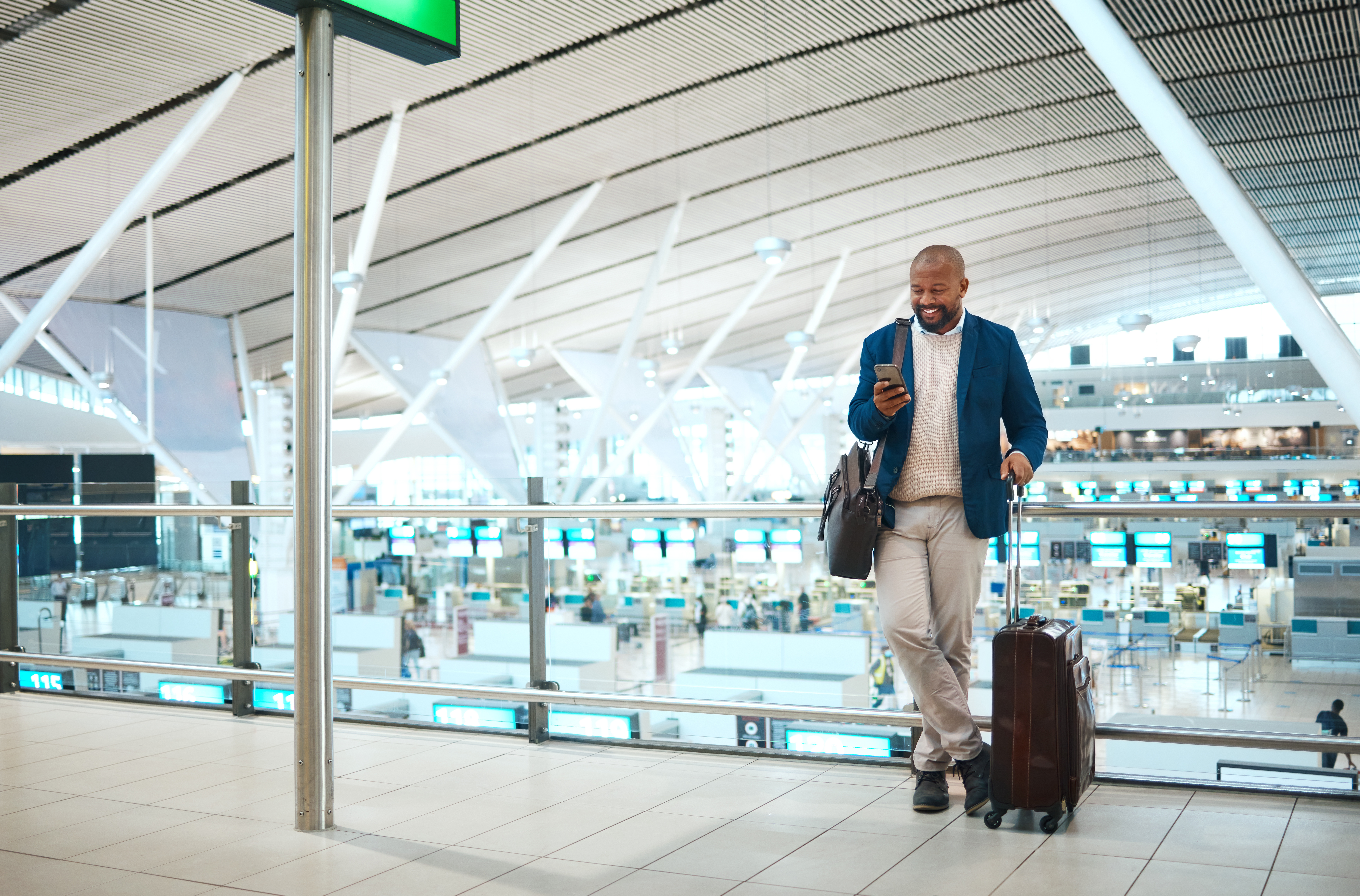 Black man standing in airport, smile and phone with online flight schedule or visa application for .